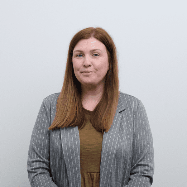 An image of Ellyn Higgins wearing a grey suit blazer and smiling at the camera.