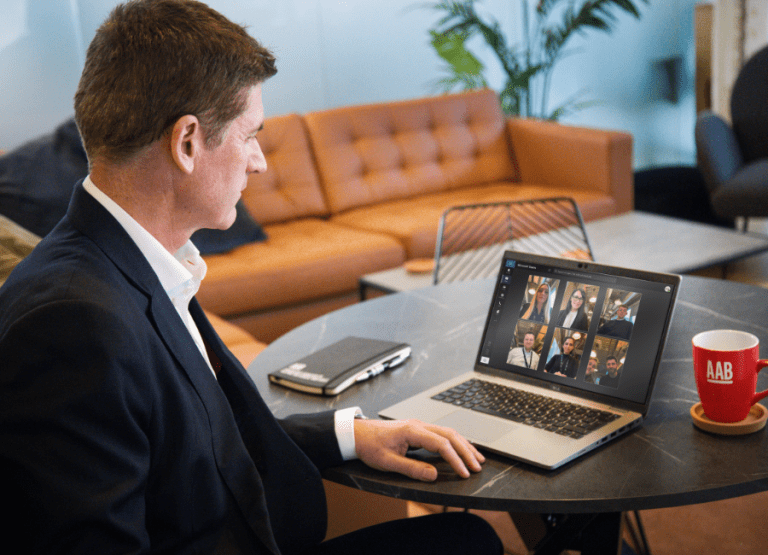 AAB team member Stuart Law on virtual meeting sitting at desk.