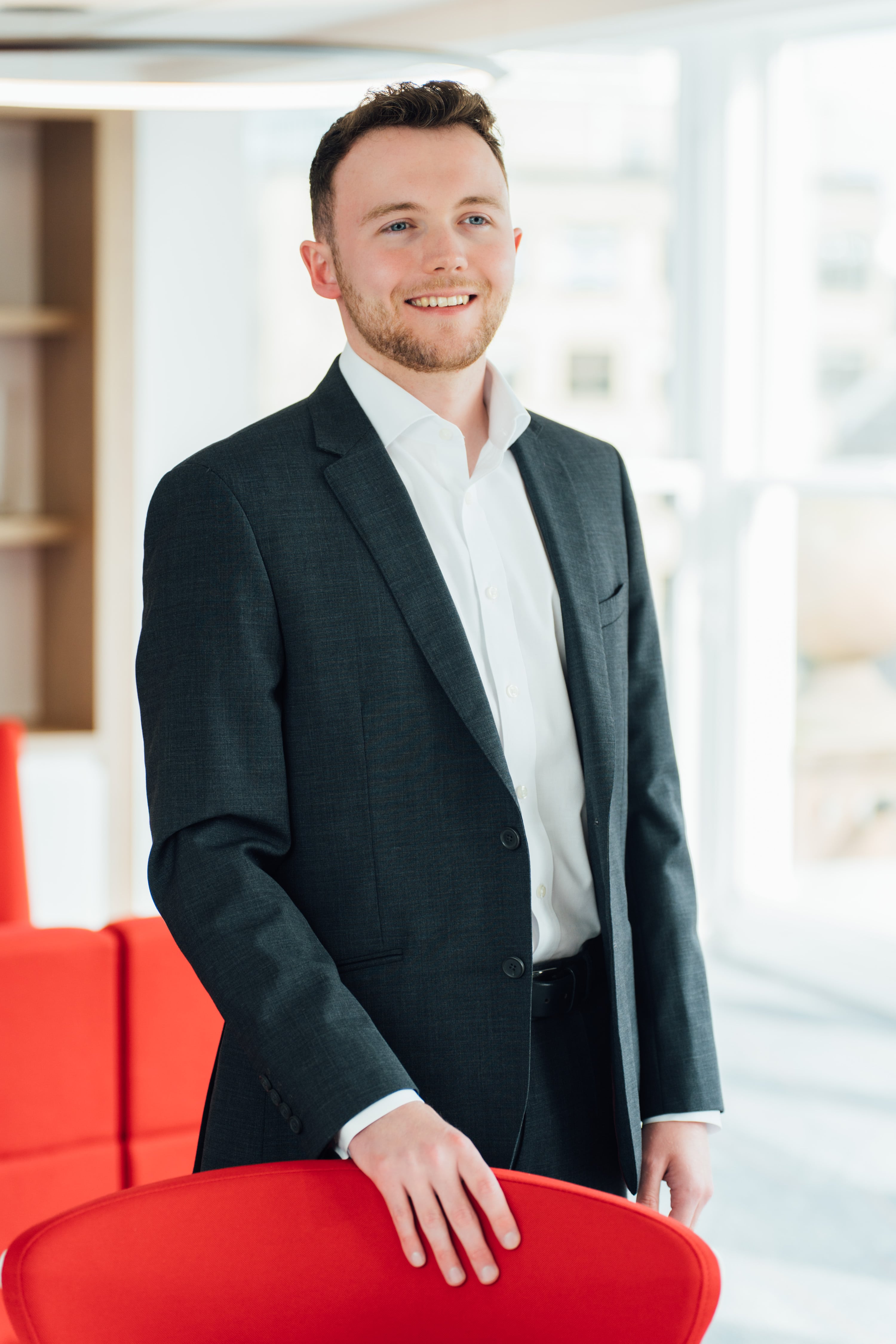 An image of Ben Weston standing in the Edinburgh office and smiling at the camera.