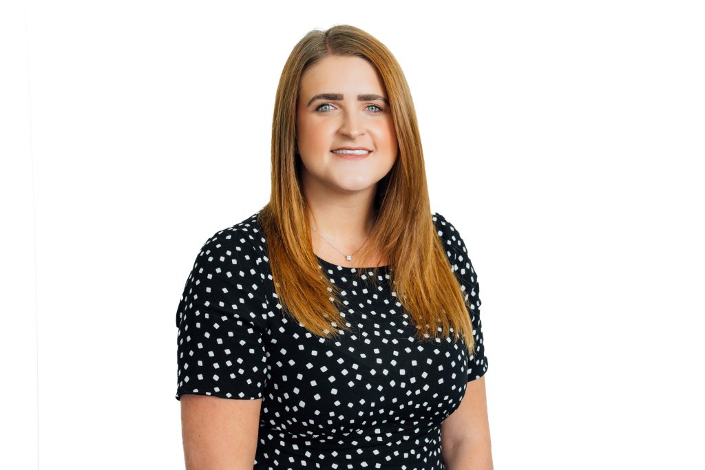 An image of Stephanie Lalley wearing a polka dot dress and smiling at the camera.