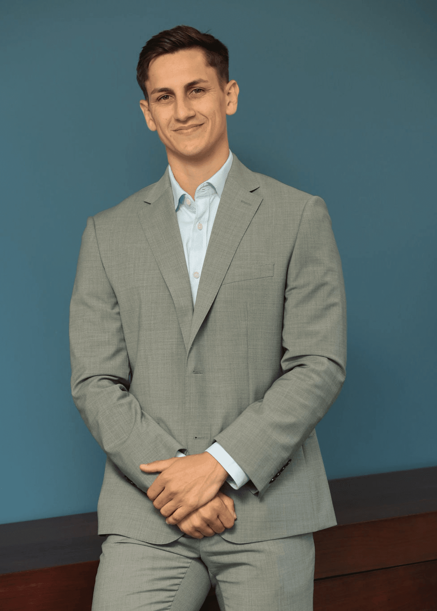 An image of David O'Doherty standing in a grey suit and smiling at the camera.