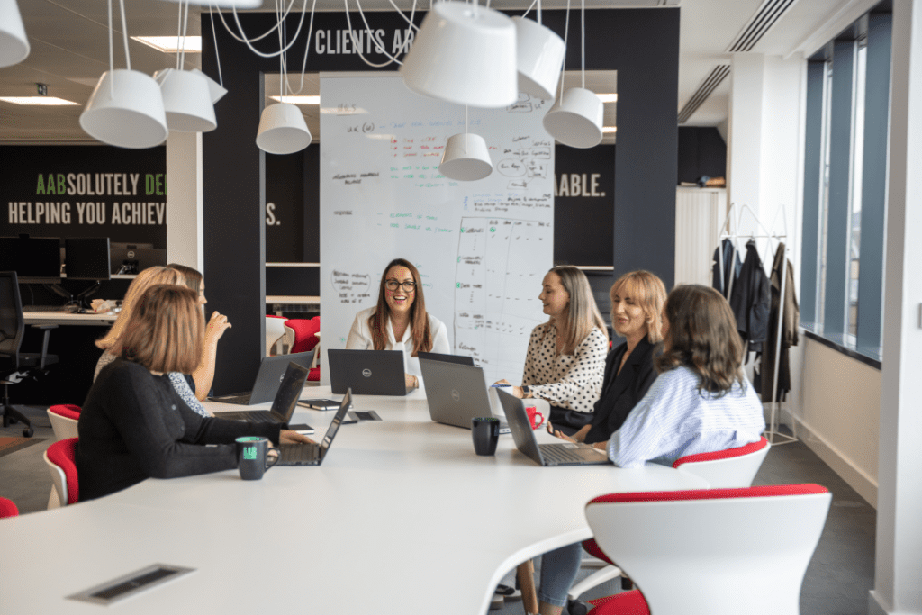 Some of the team gathered around a table in AAB's Edinburgh office