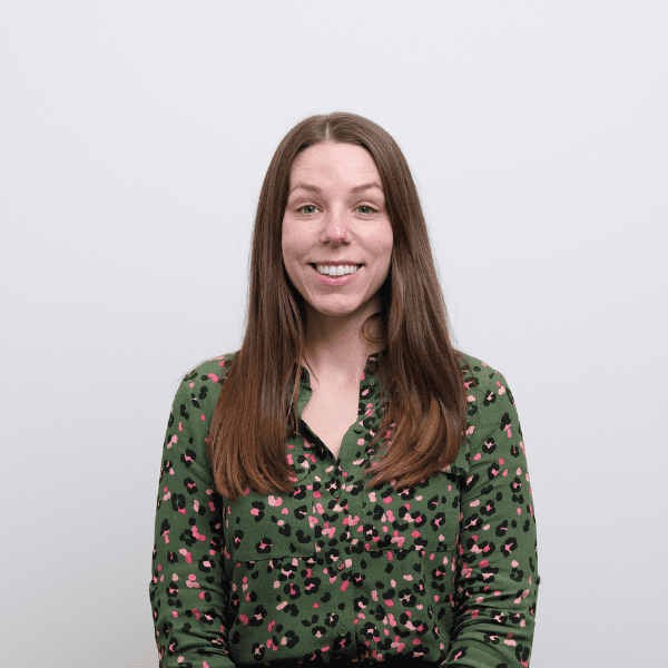 An image of Laura Cowling wearing a green top and smiling at the camera.