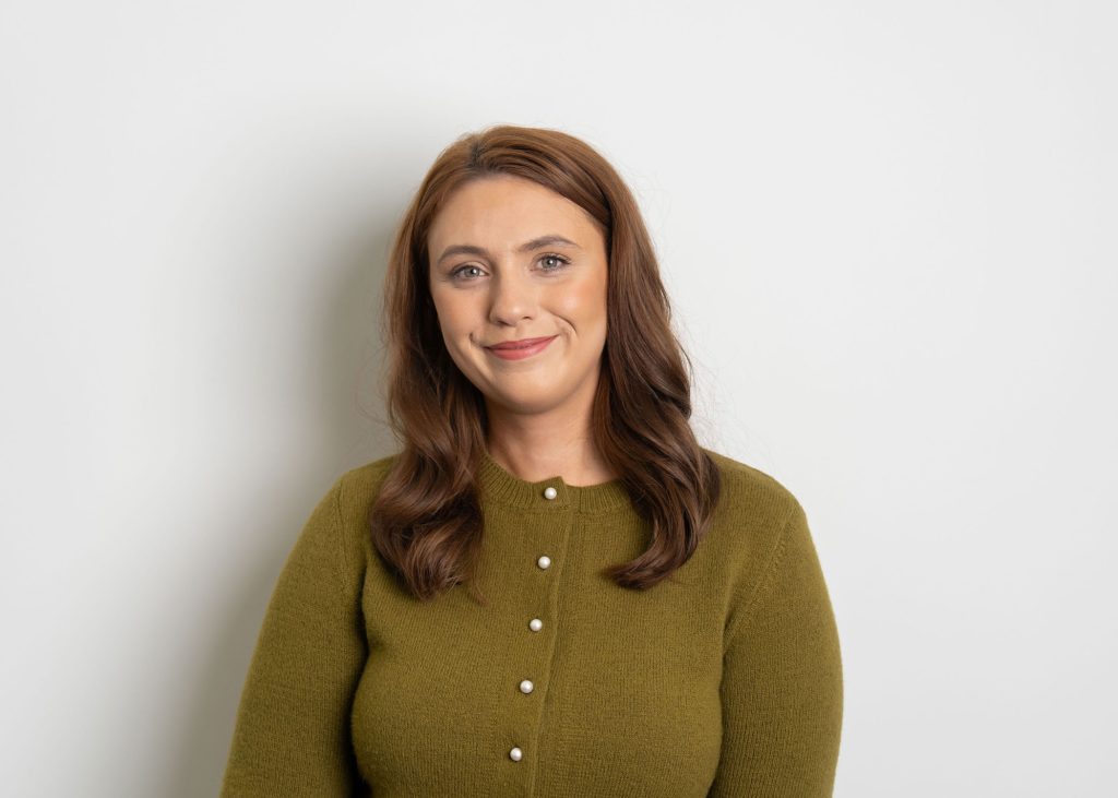An image of Nadia Anderson wearing a green top and smiling at the camera.