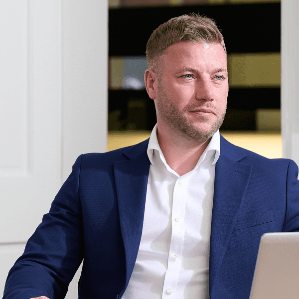 An image of Chris Cook-Martin sitting at his desk and looking out the window.