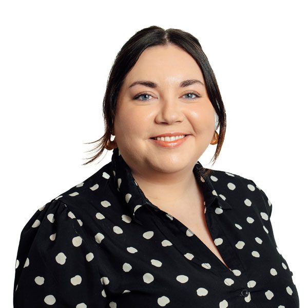 Jessica Thomson in black and white shirt smiling.