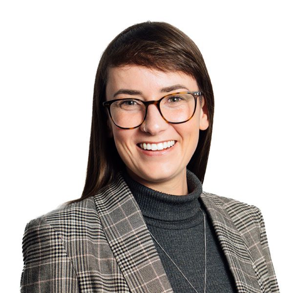 Megan Watling in patterned suit jacket smiling.