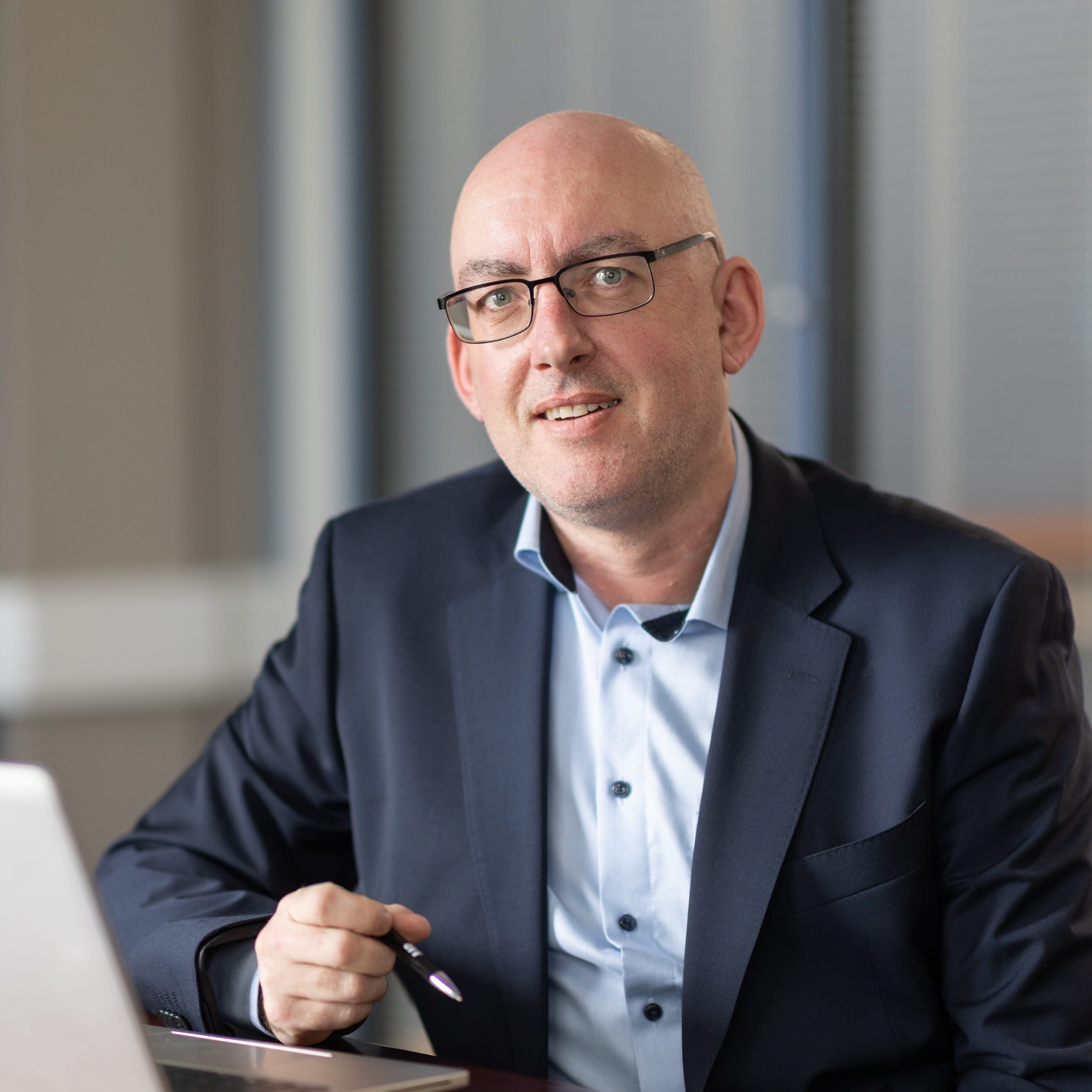 An image of Aidan McGrath sitting at a desk with a laptop.