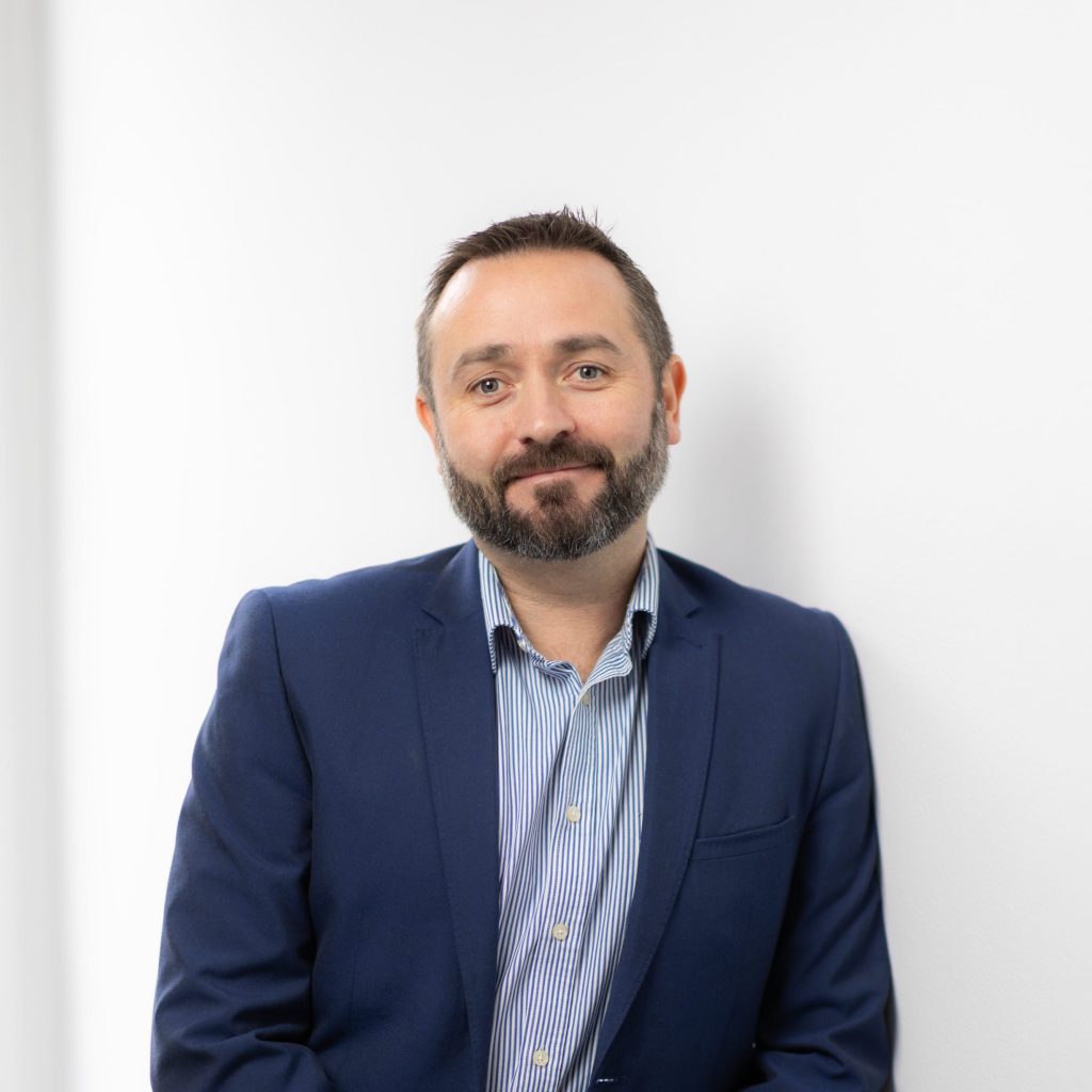An image of Jonathan Fitzpatrick wearing a blue suit jacket and blue shirt.