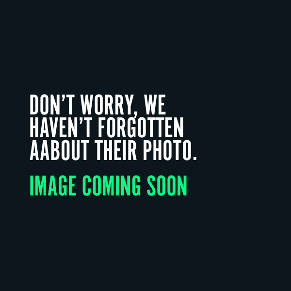 A black image with a text on it. The text is Don't worry we haven't forgotten about their photo. Image coming soon.