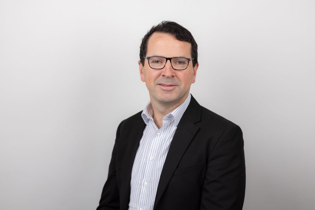 An image of Eddie Conway wearing a black suit jacket and white shirt.