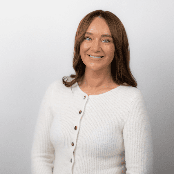 An image of Donna Blackburn wearing a white cardigan and smiling at the camera.
