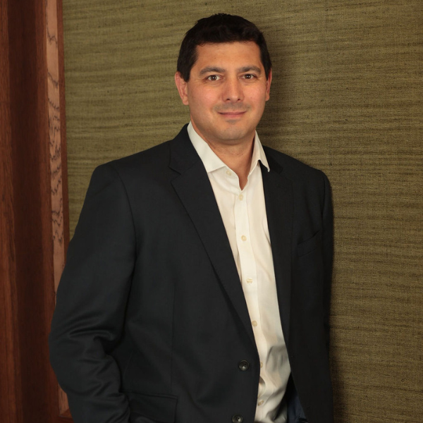 An image of Brett Silkstone standing in the office and smiling at the camera.