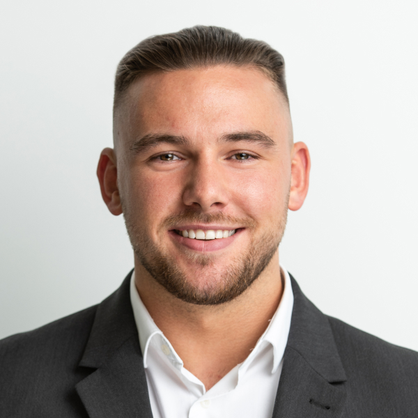 An image of Ciaran Drever wearing a white shirt and a blazer.