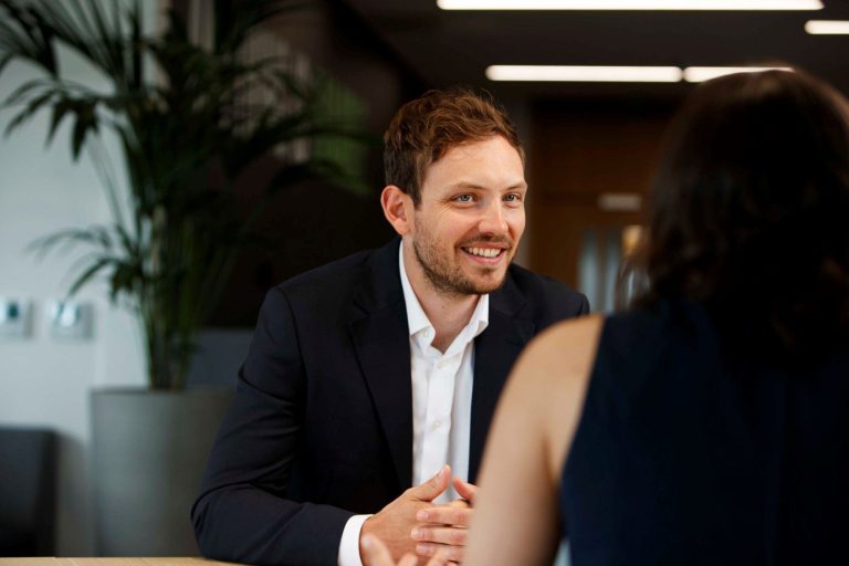 AAB employee smiling and talking with client.